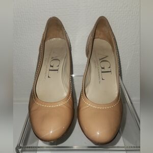 Nude patent leather stitched size 6.5 pumps. 2 inch heel.
